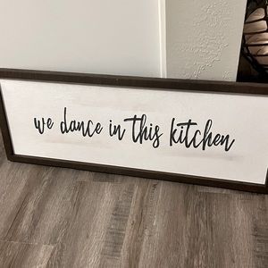 “we dance in this kitchen” sign